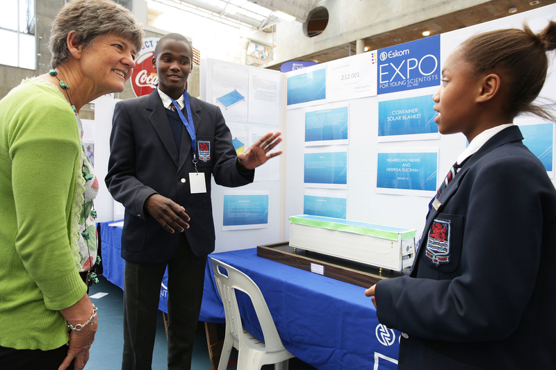 Nikwe Ngabelwa (left) and Nerissa Sucram, from Simon's Town School, tell the Deputy Dean of the Science Faculty, Prof&nbsp;Nicola Illing, about their project to use solar blankets on shipping containers.