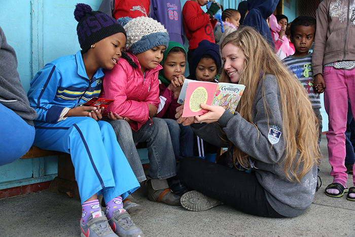 Open imagination: A UCT student attached to SHAWCO, the university's student-run community outreach initiative, reads to children in Manenberg, part of a programme to stimulate a love of reading. More than 1&nbsp;000 UCT students are part of SHAWCO's community focused health and education projects, many run in the townships.