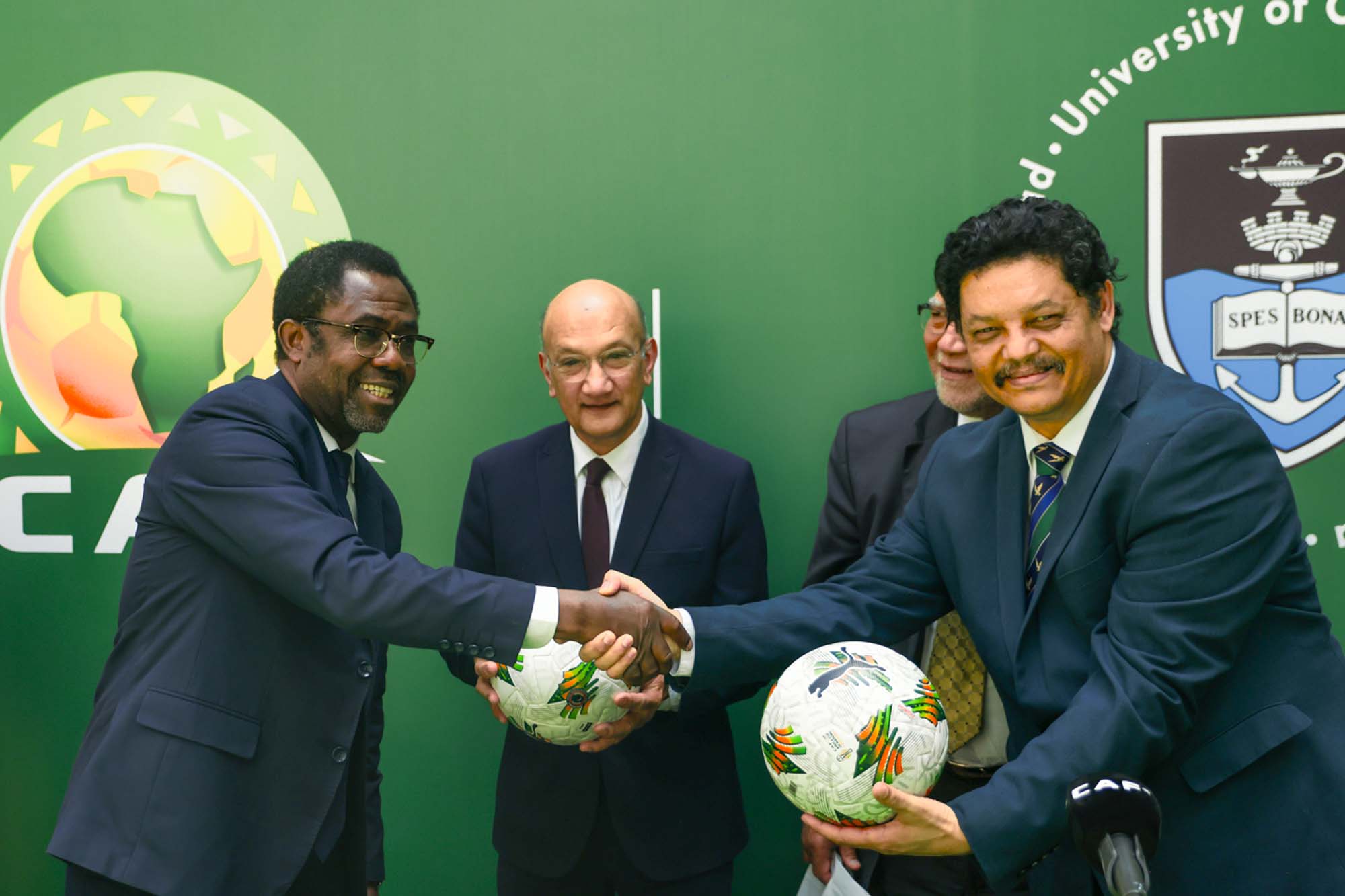 UCT Internationalisation Director, Quinton Johnson PhD, receiving the CAF football from the CAF Secretary General.