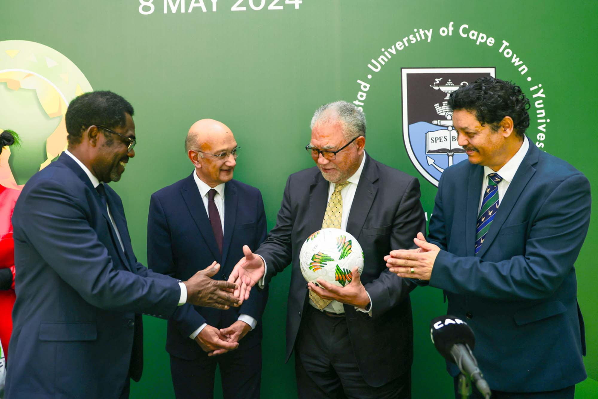 UCT Council Chair, Adv Norman Arendse SC, receiving the CAF football from the CAF Secretary General.