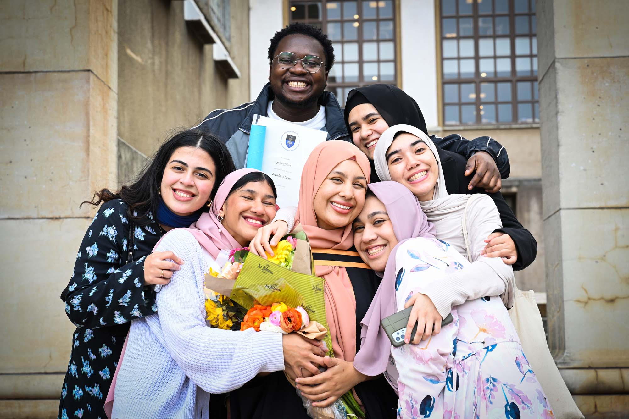 A UCT graduate (centre) celebrates with friends. Graduation is a highlight on UCT’s annual events calendar. 